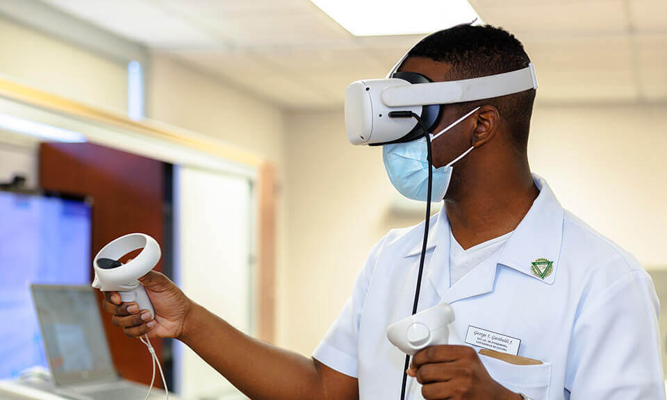 Student working with VR goggles in a lab.